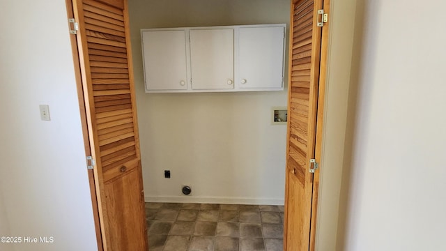 washroom with cabinet space, hookup for a washing machine, baseboards, and hookup for an electric dryer