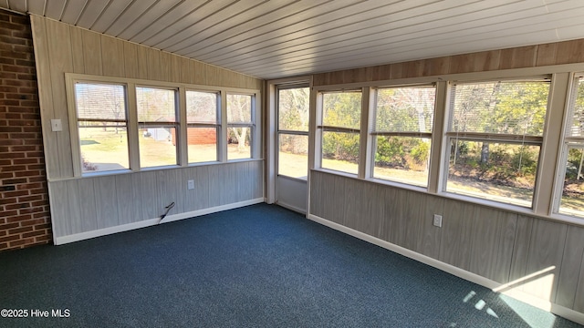 unfurnished sunroom with lofted ceiling and wood ceiling