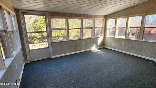 unfurnished sunroom with wood ceiling and a healthy amount of sunlight