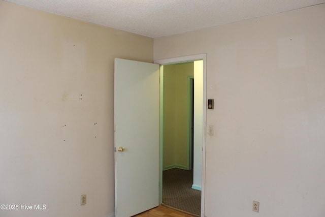 unfurnished room with a textured ceiling