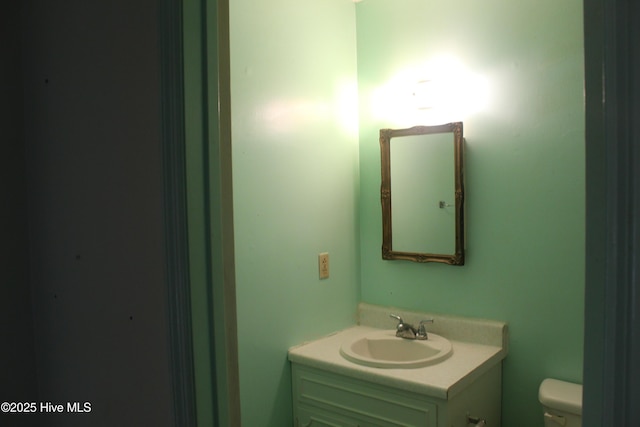 half bathroom featuring toilet and vanity