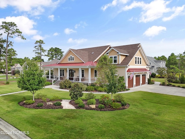 view of front facade with a garage, covered porch, driveway, and a front yard