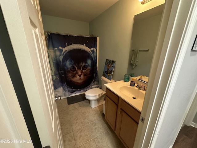 bathroom featuring toilet, curtained shower, tile patterned flooring, and vanity