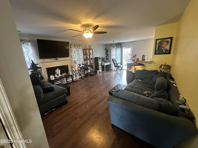 living room with dark wood-style floors, a fireplace, and a ceiling fan