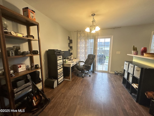 office area with dark wood-type flooring and an inviting chandelier