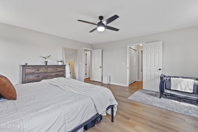 bedroom featuring ceiling fan, wood finished floors, and baseboards