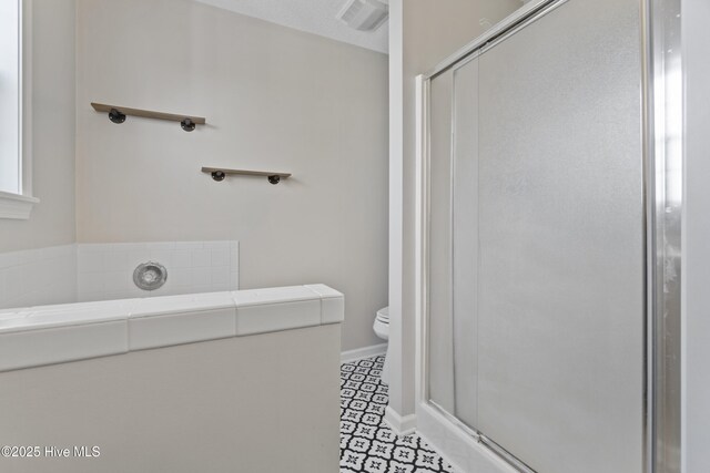 full bathroom with toilet, a stall shower, visible vents, and baseboards