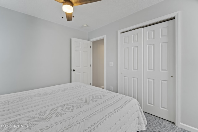 bedroom featuring ceiling fan, a closet, and carpet flooring