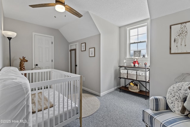 bedroom with carpet, lofted ceiling, a ceiling fan, a textured ceiling, and baseboards