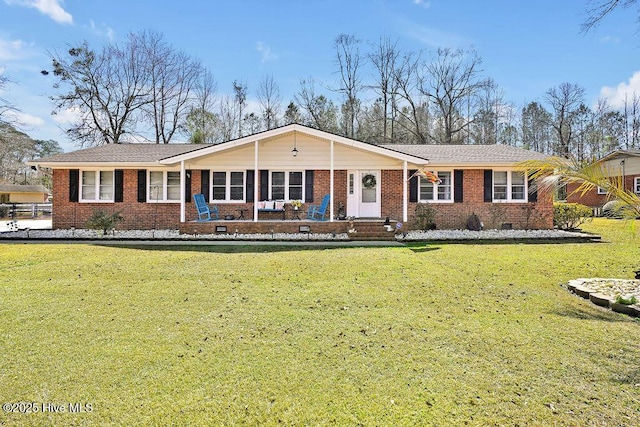 ranch-style home featuring crawl space, brick siding, and a front lawn