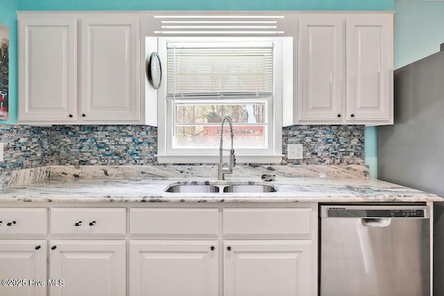 kitchen with a sink, backsplash, dishwasher, and white cabinets