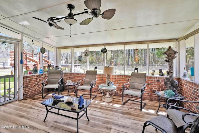 sunroom featuring a healthy amount of sunlight and a ceiling fan