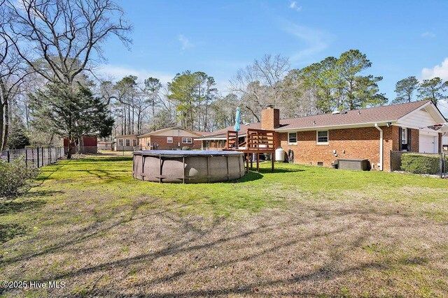 view of yard featuring a fenced in pool and fence