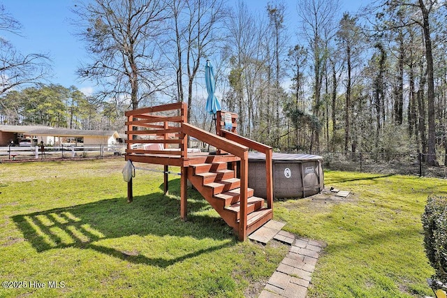 view of yard featuring an outdoor structure, a playground, and a fenced backyard