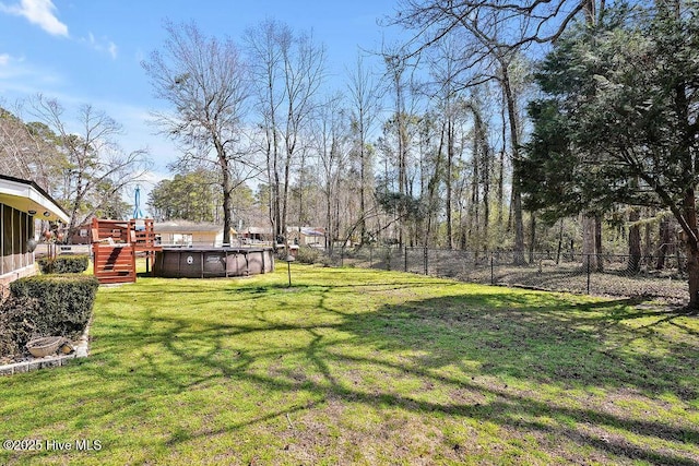 view of yard with an outdoor pool and a fenced backyard