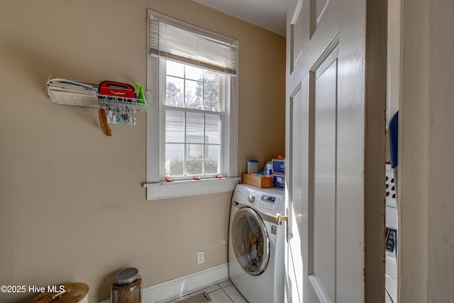 washroom with laundry area, baseboards, washer / clothes dryer, and tile patterned flooring