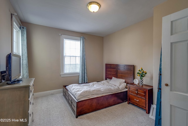 bedroom featuring baseboards and light colored carpet