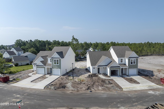 211 Sandpiper Pl, Holly Ridge, NC 28445 - view of front of house with driveway, an attached garage, and a wooded view