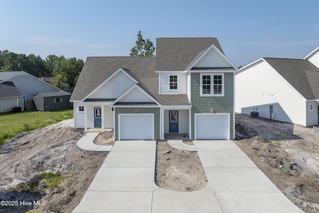 211 Sandpiper Pl, Holly Ridge, NC 28445 - traditional-style house featuring a shingled roof, driveway, and board and batten siding