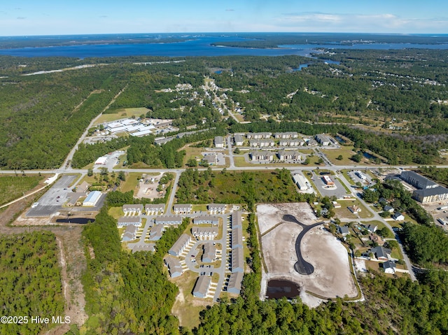 birds eye view of property with a view of trees