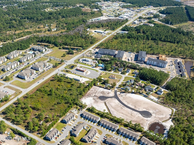 birds eye view of property featuring a wooded view