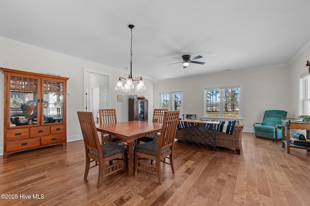 dining area featuring light wood-style floors, a healthy amount of sunlight, and baseboards