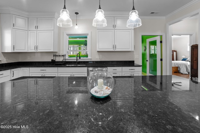 kitchen featuring white cabinetry, visible vents, and a sink