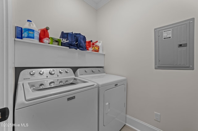 washroom featuring laundry area, electric panel, baseboards, and washer and clothes dryer