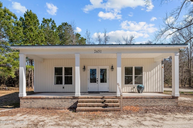 exterior space with covered porch and french doors