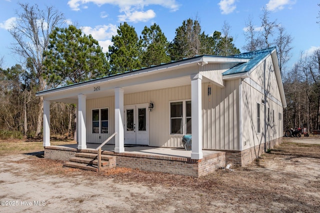 view of front of property featuring covered porch and french doors