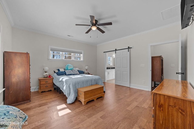 bedroom with a barn door, visible vents, baseboards, light wood-style flooring, and ornamental molding