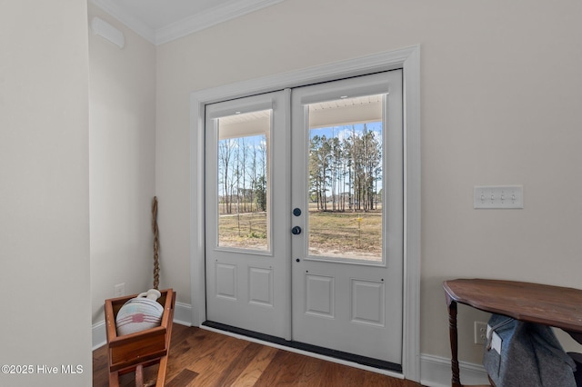 entryway with dark wood-style floors, baseboards, crown molding, and french doors