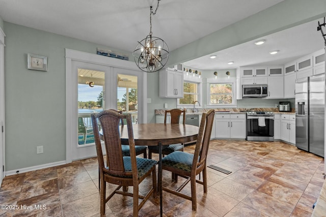 dining area featuring recessed lighting, a notable chandelier, baseboards, and visible vents