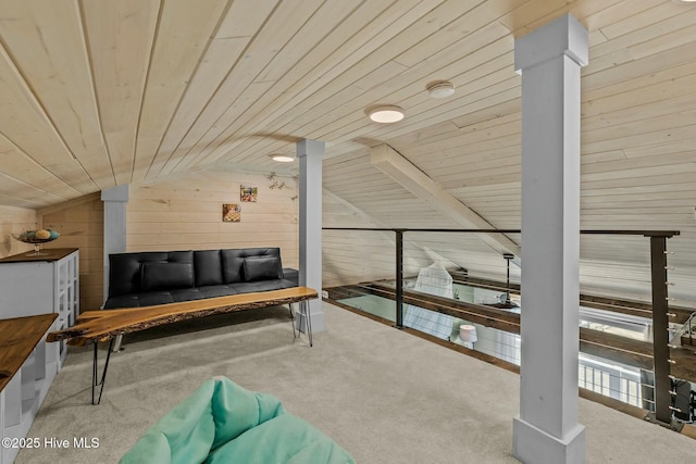 sitting room with carpet floors, wooden walls, wooden ceiling, and vaulted ceiling