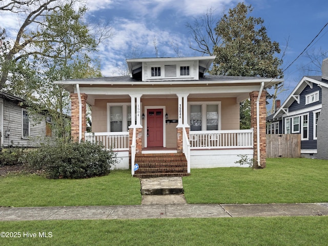 bungalow-style home featuring a porch and a front yard