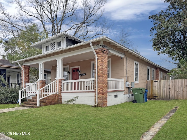 bungalow-style house featuring crawl space, a porch, a front lawn, and fence