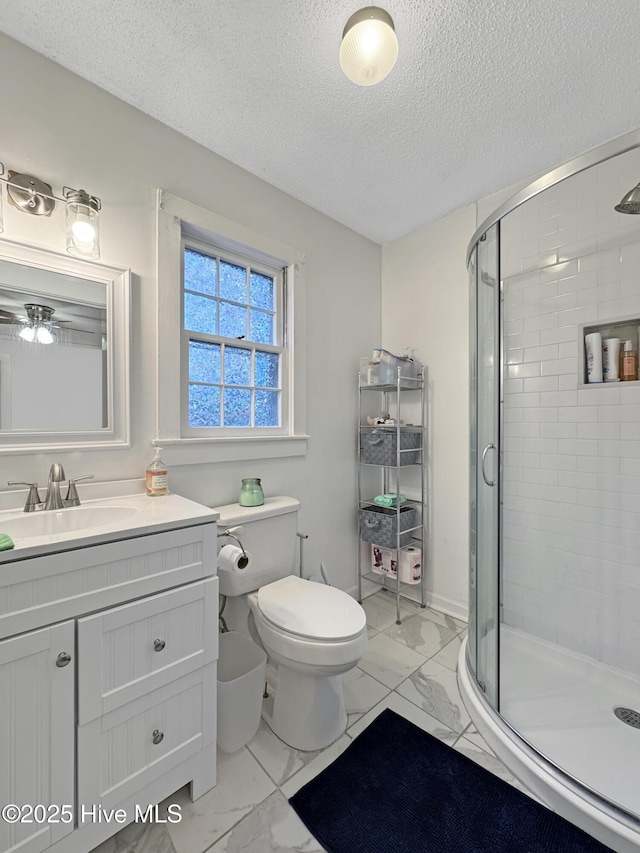 bathroom with vanity, a shower stall, toilet, and marble finish floor