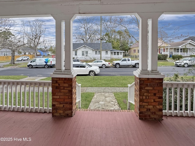 wooden deck with a residential view and covered porch