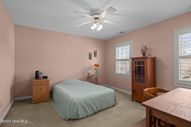 bedroom featuring visible vents, carpet, a ceiling fan, and baseboards