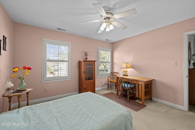 bedroom with baseboards, visible vents, ceiling fan, and light colored carpet