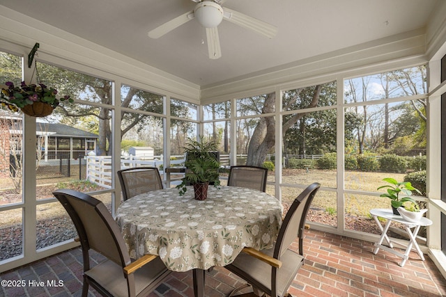 sunroom with plenty of natural light and a ceiling fan