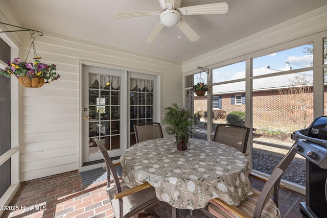 sunroom / solarium featuring ceiling fan