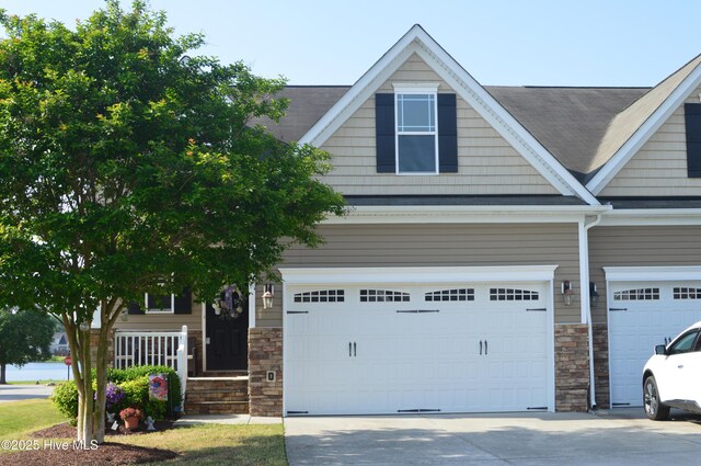 63 Radcliffe Ct, Clayton, NC 27527 - view of front of property with a garage, roof with shingles, driveway, and stone siding