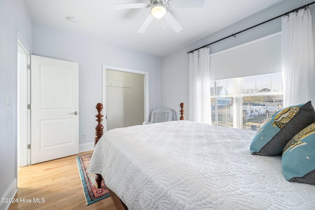 bedroom featuring a ceiling fan, baseboards, and wood finished floors