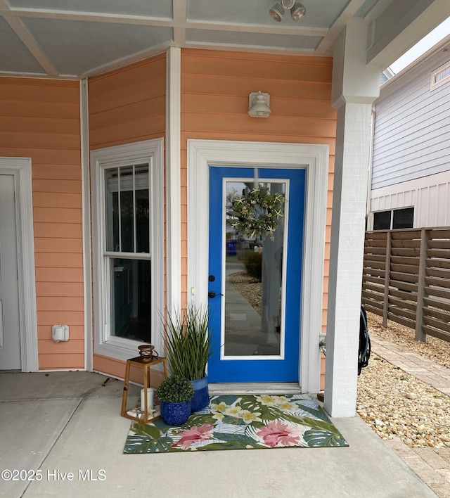 entrance to property featuring fence