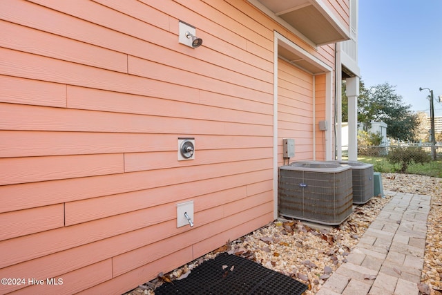 exterior space featuring fence and central AC