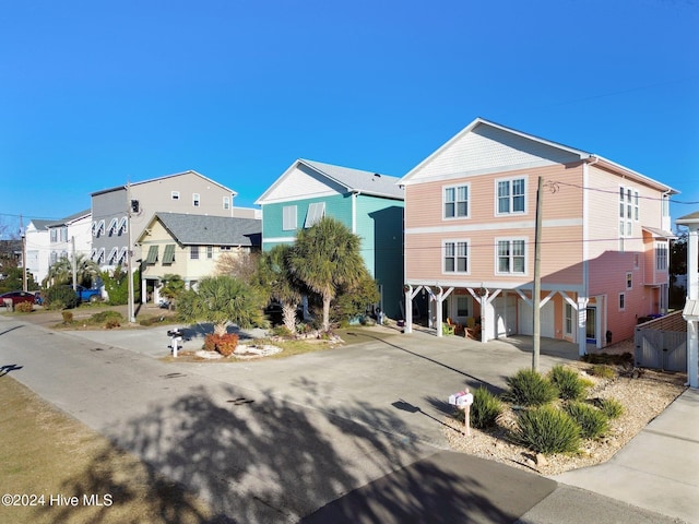 view of front of home featuring a carport, a residential view, and driveway