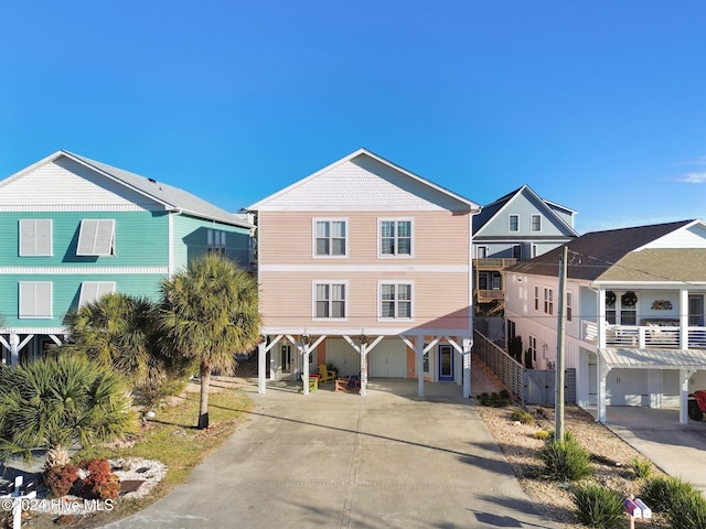 coastal inspired home with a carport and concrete driveway