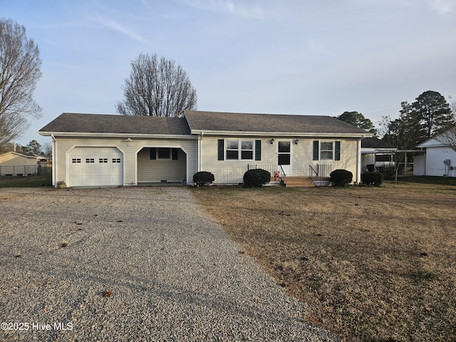 ranch-style home with driveway and a garage