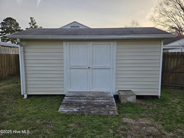 view of shed featuring fence